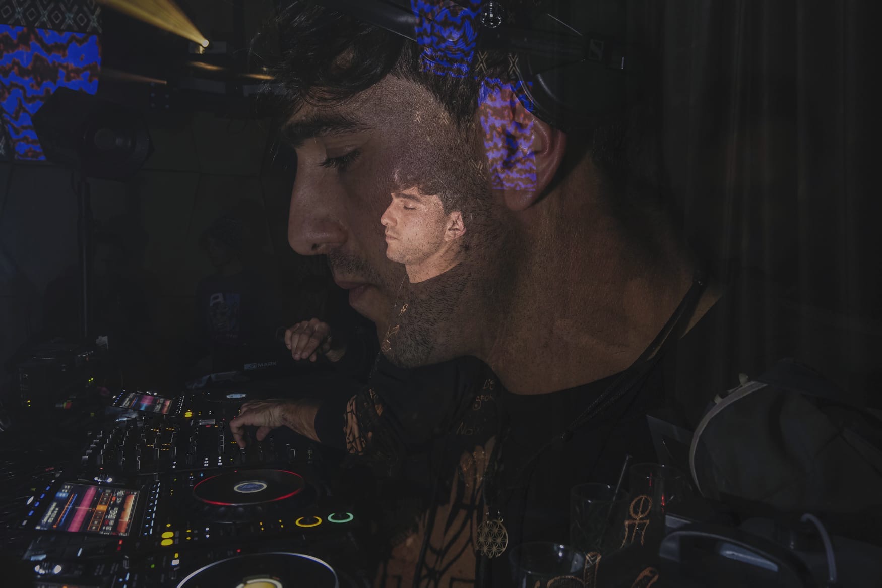 Double-exposure portrait of ORIAM in the booth